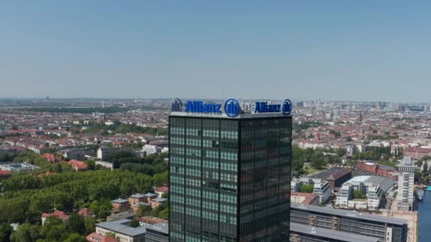 Orbiting around tall modern commercial building. Aerial view of town and Spree river. Downtown in distance. Berlin, Germany — Stock Video