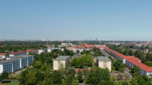 Rising shot of suburbs. Housing estate near main railway track. Tall buildings in downtown in distance. Berlin, Germany — Stock Video