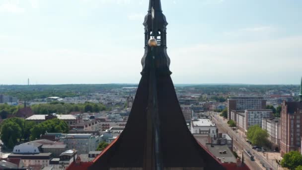 Close up shot of church steeple lantern. Fly around top of tower with bell. Panoramic aerial view of city — 비디오