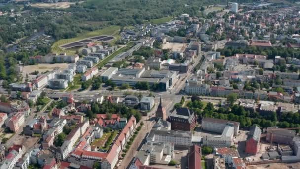 Aerial panoramic view of town. Historic buildings, gabled houses and newer buildings in distance. Road intersection at Steintor town gate — Stock videók