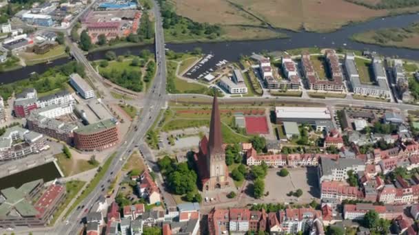 Tilt down aerial shot of Saint Peters church. Old and famous religious building with tall and pointed spire. Traffic on multi lane road leading around — 비디오