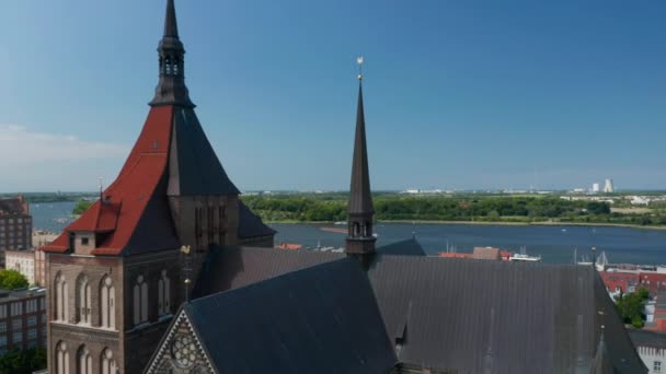 Backwards reveal of Saint Mary church and surrounding buildings. Medieval brick gothic basilica — Stock videók