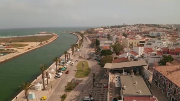 Establishing aerial drone view of Lagos city by sea, Algarve, Portugal, downtown cityscape, tilt down to birds eye overhead top down view of Gil Eanes square, day — 图库视频影像