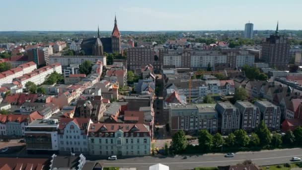 Forwards and tilt down reveal of buildings in town. Close-up of wide street with tram tracks — Stockvideo