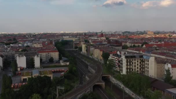 Forwards fly above railway junction. Tracks leading between residential tenement houses in city. Berlin, Germany — Stock Video