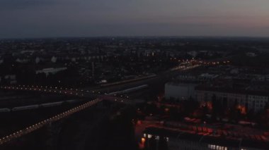Tren istasyonuna giden trenin hava görüntüsü. Tren raylarında trafik vardı. Gün doğmadan önce şehir. Berlin, Almanya