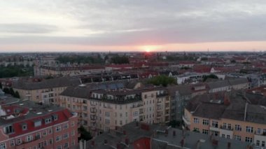 Şehir merkezindeki evlerin tersten ortaya çıkarılması. Caddelerin ve şehirdeki binaların üzerinden uç. Doğan güneşe karşı görüş. Berlin, Almanya