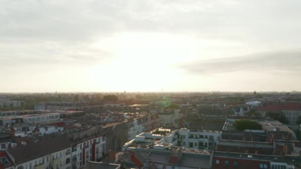 Backwards reveal of residential buildings in large town. Morning footage against bright sky. Berlin, Germany — Stock Video