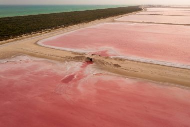 Aerial view of the pink salt lakes separated by a sand spit from the Gulf of Mexico on the Yucatan in Mexico clipart