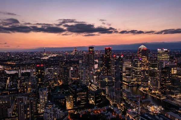 Vista panorámica del horizonte aéreo del este de Londres por la noche con rascacielos de Canary Wharf y hermoso cielo colorido en el fondo —  Fotos de Stock