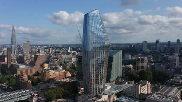 Ascending footage of One Blackfriars tall modern building with shiny glass facade. The Shard skyscraper in background. London, UK — Stock Video