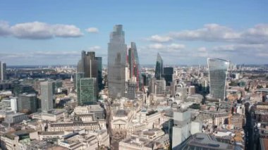 City 'nin finans ve ekonomi bölgesindeki bir grup modern yüksek ofis binasının kaydırak ve pan görüntüleri. Kaypak 'tan Thames nehrinin karşısındaki Tower Köprüsü' ne. Londra, İngiltere