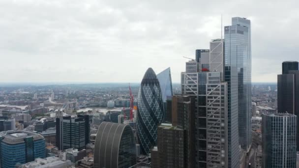 Forwards fly above downtown. Heading towards City skyscrapers. Iconic round shaped building with twisted pattern looks like gherkin. London, UK — Stock Video