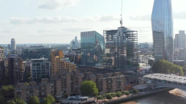 Panorama curva tiro de edifícios na margem sul do rio Tamisa. Construção de novos edifícios altos modernos com fachada de vidro brilhante. Londres, Reino Unido — Vídeo de Stock