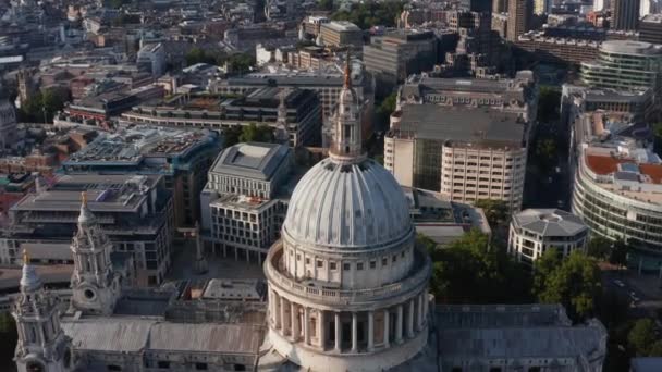 Latać nad kopułą zabytkowej katedry św. Pawła w popołudniowym słońcu. Przechyl się na zdobionej wieży z krzyżem na szczycie. Londyn, Wielka Brytania — Wideo stockowe