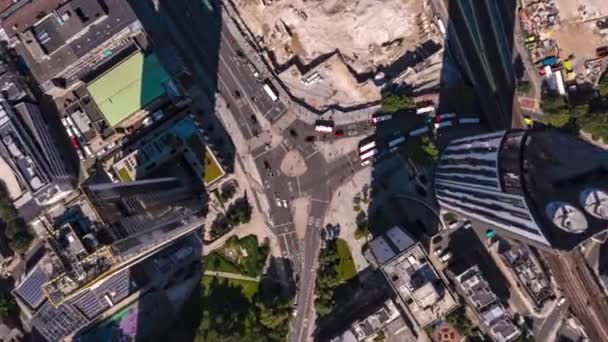 Aerial birds eye overhead top down descending hyperlapse footage of traffic on road intersection between Elephant and Stata tall buildings in sunny afternoon. London, UK — Stock Video