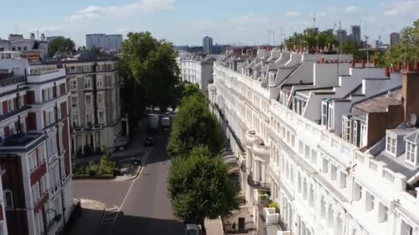 Aerial view of street with white town houses. Row of chimneys on roof. Sunny day in urban neighbourhood. London, UK — Stock Video