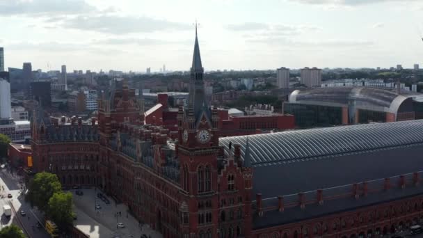 Slide and pan shot of historic brick building in Victorian style. St Pancras train station in Camden borough. London, UK — Stock Video