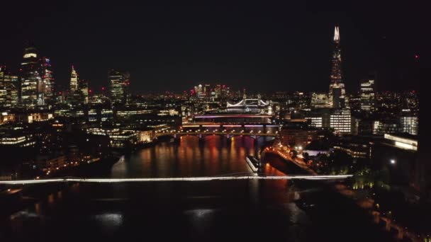 Forwards fly above Thames river. Night scene of city centre. Calm water surface reflection city lights. London, UK — Stock Video