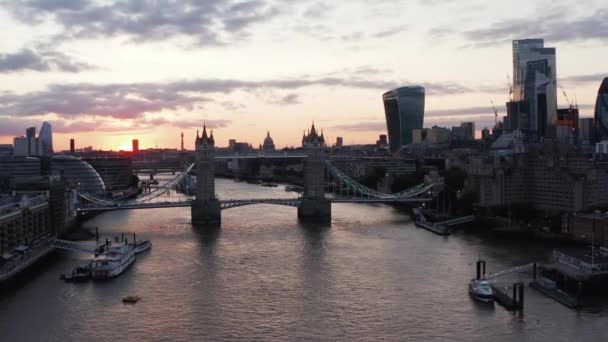 Hacia adelante vuelan por encima del río Támesis al atardecer. Vista de Tower Bridge y rascacielos modernos en el centro financiero de la ciudad. Londres, Reino Unido — Vídeos de Stock