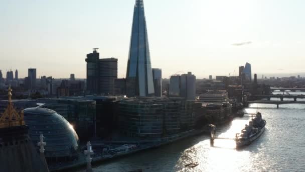 Pilvenpiirtäjä Thames-joen etelärannalla kirkkaita pilviä vasten taivaalla. Taaksepäin ja ylös Tower Bridgelle. Lontoo, Yhdistynyt kuningaskunta — kuvapankkivideo