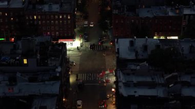 Geceleri hareketli bir New York kavşağının havadan görünüşü ikonik sarı taksileri ve canlı şehir yaşamını vurguluyor..
