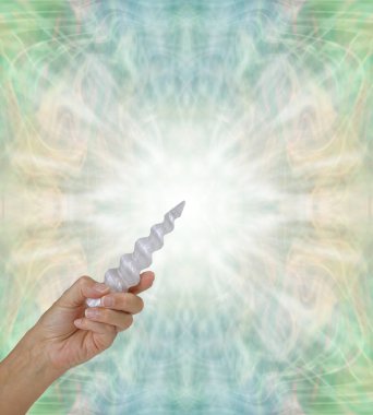 Crystal Healing with a Selenite Spiral Wand  - female hand holding beautiful  carved selenite spiral wand in left hand pointing it upwards against a soft sage green symmetrical pattern background with copy space  clipart