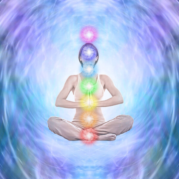 Meditating on the Seven Chakra with Vortex energy - female seated in lotus position with a column of seven chakras surrounded by cool blue purple  energy formation background with copy space