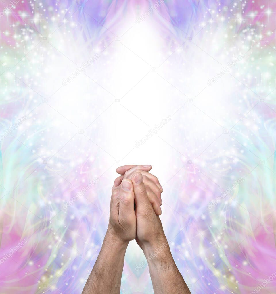 Praying for help from the Angelic Realms - male hands clasped in prayer position against a bright white Angel form and beautiful pale multicoloured spiritual energy behind