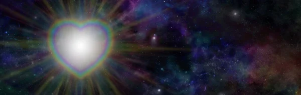 Cosmic Rainbow Heart Light background - dark starry night deep space background and rainbow coloured heart with  rainbow coloured light radiating outwards and copy space on right