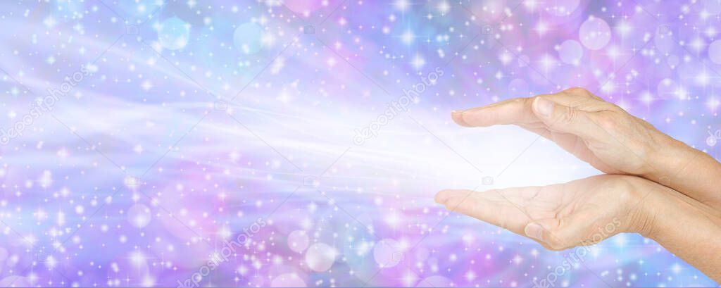 Beaming Energy from Palm Chakras Healing Banner - female cupped parallel hands on right side against a sparkling purple pink blue bokeh background with plenty of copy space