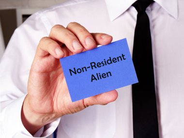  Financial concept meaning Non-Resident Alien with sign on the piece of paper clipart