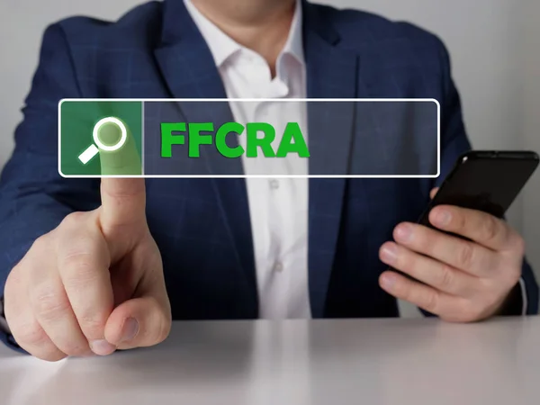 Search Families First Coronavirus Response Act FFCRA button. Modern Loan officer use cell technologies.