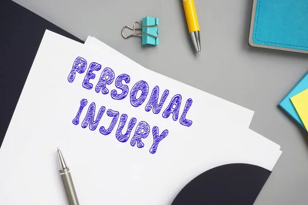 Financial concept meaning PERSONAL INJURY with inscription on the sheet.