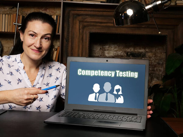 Financial concept about Competency Testing with sign on laptop