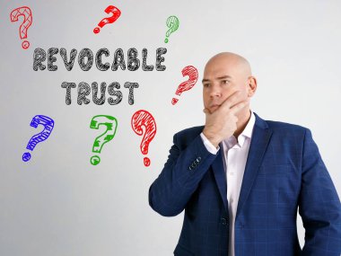 Business concept about REVOCABLE TRUST question marks with sign on the gray wall clipart