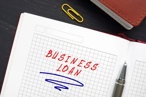 Business concept about BUSINESS LOAN with inscription on the sheet. A business loan is a loan specifically intended for business purpose