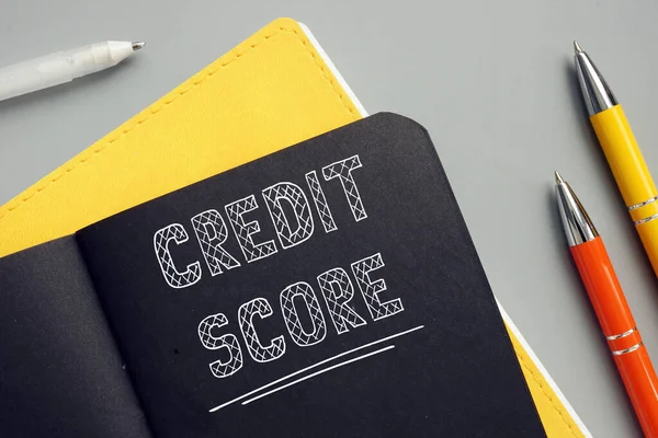 Business concept about CREDIT SCORE with phrase on the page. A credit score is a numerical expression based on a level analysis of a person\'s credit file