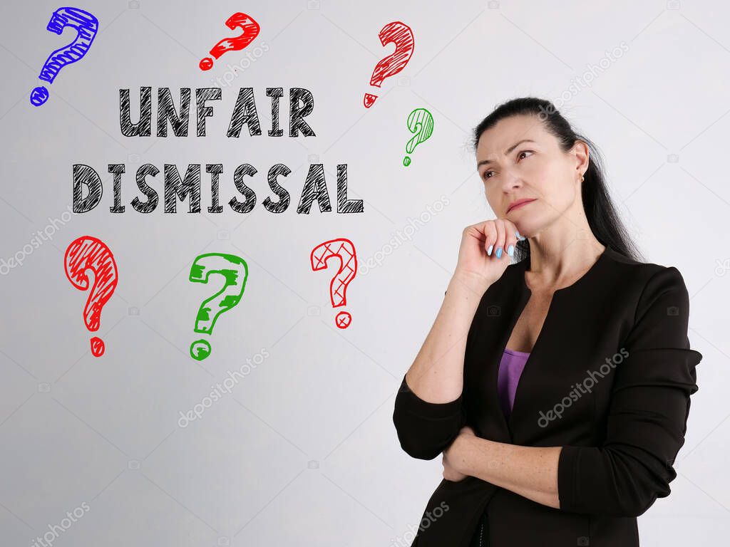  UNFAIR DISMISSAL question marks inscription on the gray wall