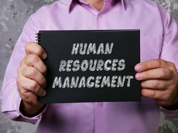 Financial concept meaning HUMAN RESOURCES MANAGEMENT with sign on the sheet.