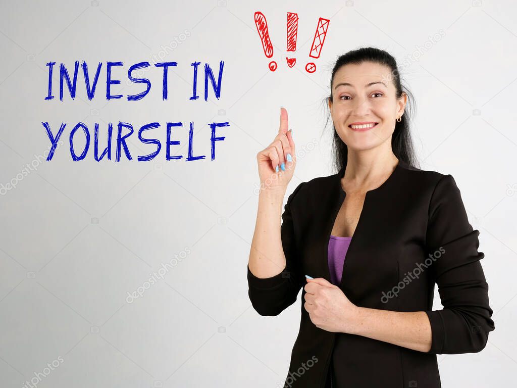 Financial concept about INVEST IN YOURSELF exclamation marks with inscription on the wall