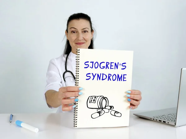 SJOGREN\'S SYNDROME text in list. Doctor looking for something at laptop