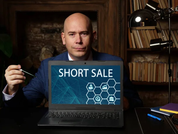 Business concept meaning SHORT SALE with phrase on the laptop. Business photo shows the sale of an asset or stock that the seller does not ow