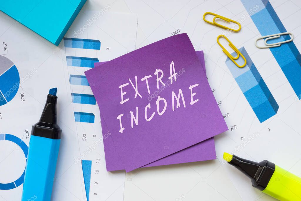  Financial concept about EXTRA INCOME with inscription on the sheet.