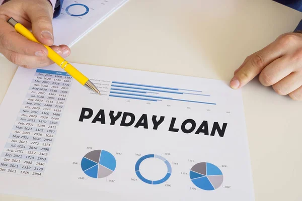 Business concept about PAYDAY LOAN with inscription on the printout with diagrams and tables.