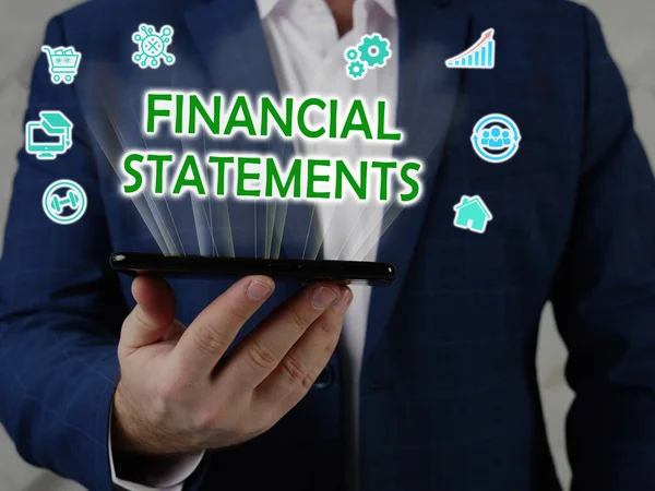 FINANCIAL STATEMENTS phrase on the screen. Businessman use internet technologies at office. Concept search and FINANCIAL STATEMENTS .
