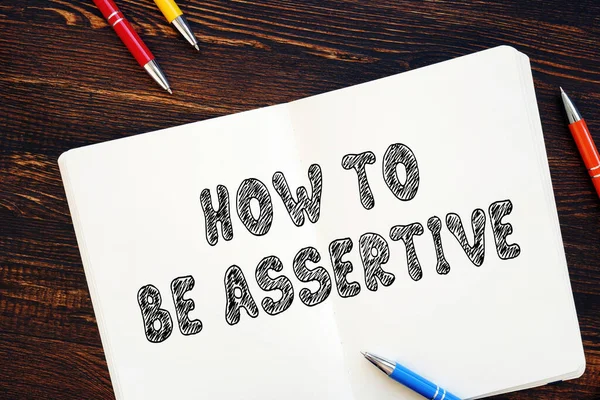 Business concept meaning How to Be Assertive with phrase on the sheet.