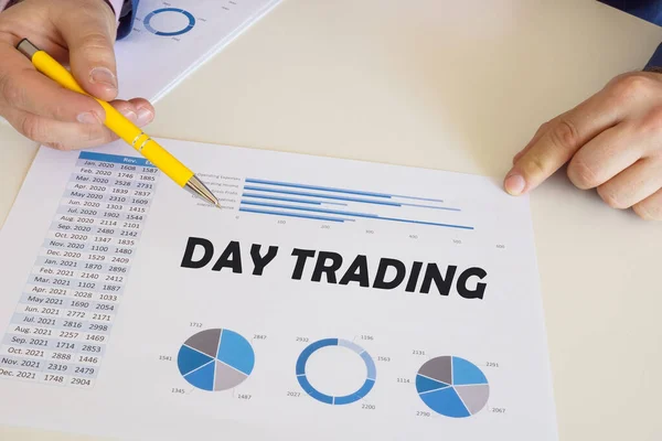 Financial concept about DAY TRADING with phrase on the printout with diagrams and tables.