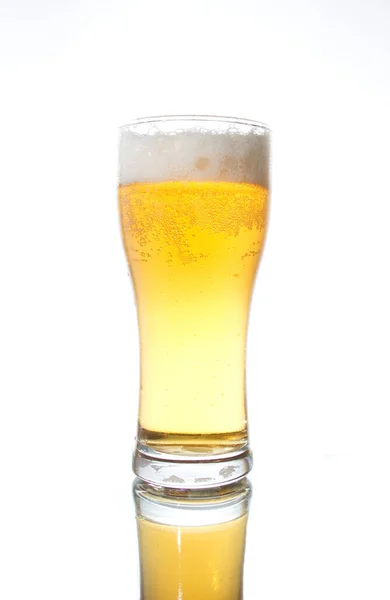 A glass of beer stands on a white background