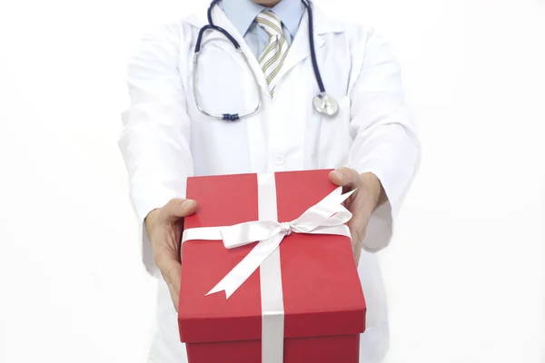 Medical doctor holding gifts in hands — Stock Photo, Image